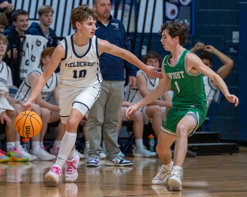 Kash Klendworth (10) of Fieldcrest dribbles ball as Joe Duffy (1) of Dwight guards on Monday, December 15, 2025 at Fieldcrest High School in Minonk.