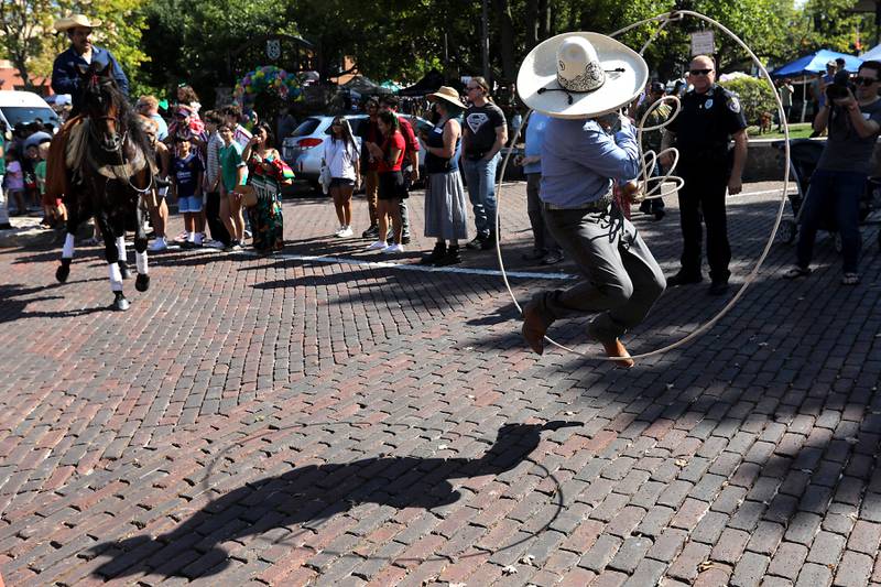 A man jumps through his lasso during the house parade on Sunday, Sept. 14, 2025,, during the annual Hispanic Connections Mexican Independence Day Celebration  in the Historic Woodstock Square. The celebration featured music, food and culture.