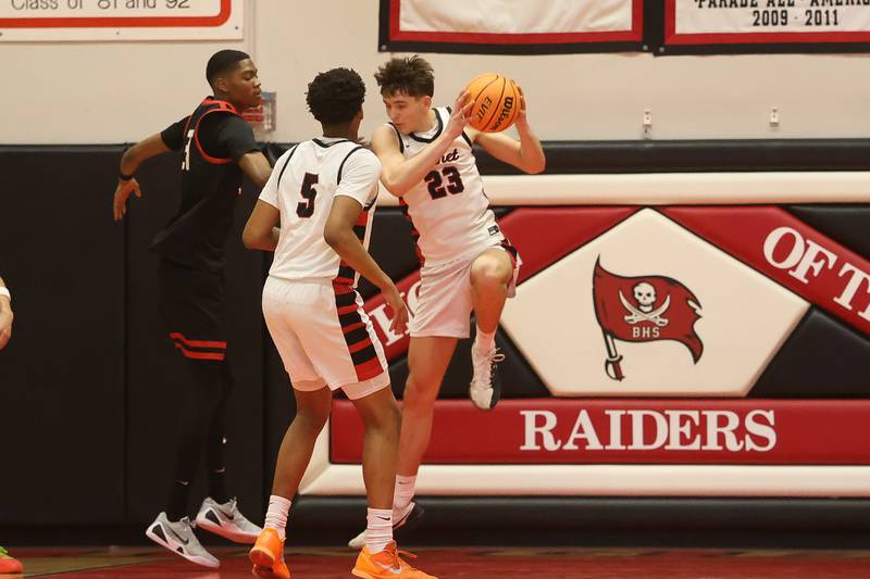 Benet’s Edvardas Stasys pulls in the rebound against Bolingbrook in the Class 4A Bolingbrook Sectional championship game on Friday, March 6, 2026 in Bolingbrook.
