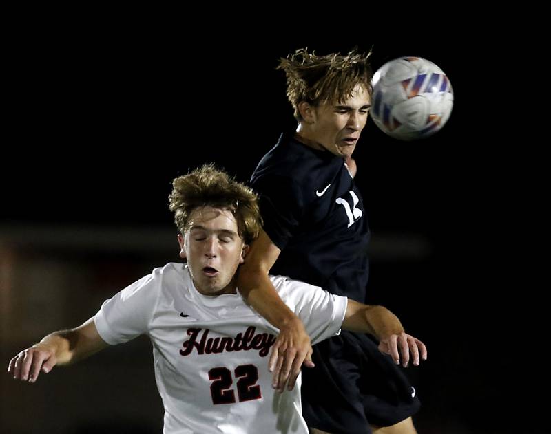 McHenry's Kyren Rivard heads the ball away from Huntley's Tyler Murray during a Fox Valley Conference boys soccer match on Thursday, Oct. 9, 2025, at McCracken Field in McHenry.