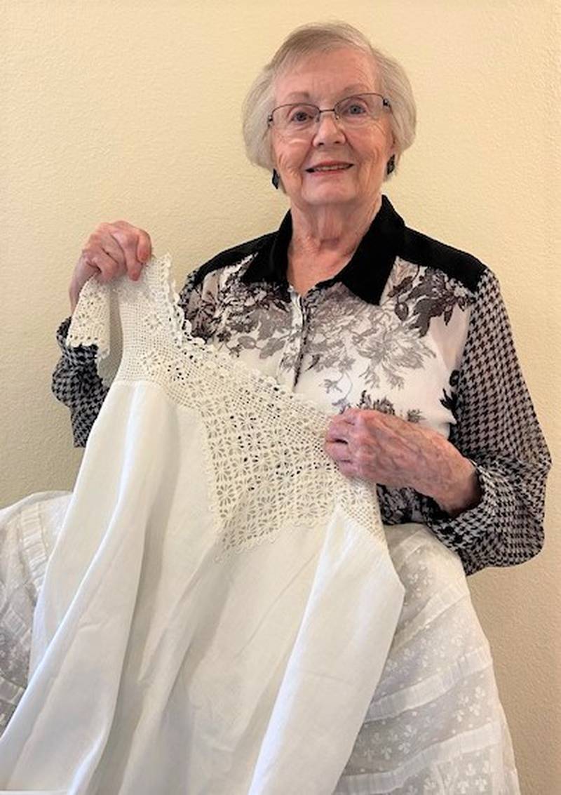 Florence Finfgeld, Textile Chairman of the Marshall County Historical Society Museum, displays one of the many undergarments shown during her presentation of "What Is Under There?" at the May meeting of the Chief Senachwine DAR Chapter.
