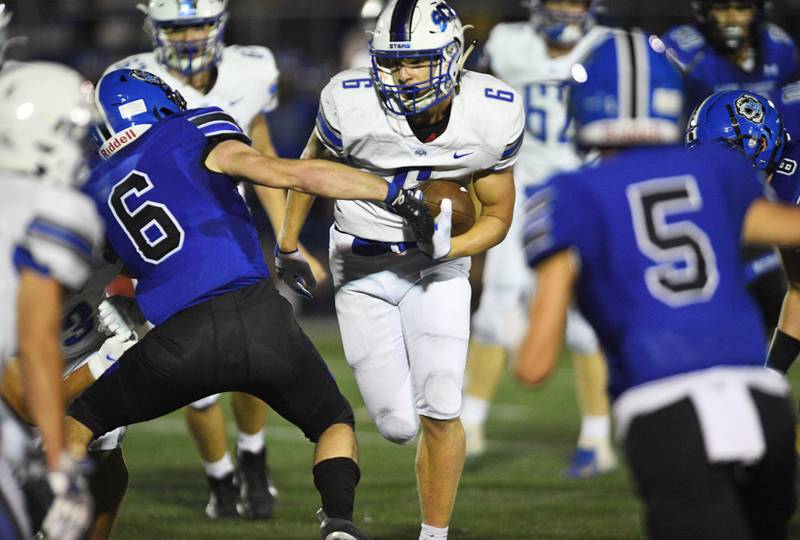 St. Charles North's Drew Surges runs against Lake Zurich's Tyler Erkman in a football game in Lake Zurich Friday, September 3, 2021.