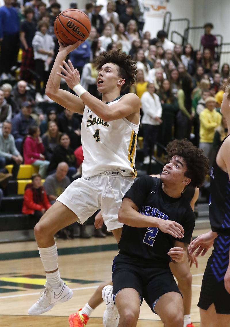 Crystal Lake South's AJ Demirov drivers to the basket against Burlington Central's Caden West during a Fox Valley Conference boys basketball game on Friday, Dec.1, 2023, at Crystal Lake South High School.
