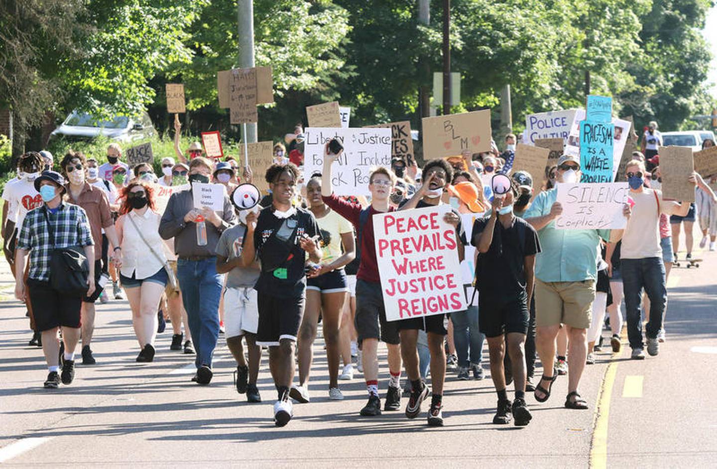 Participants head north on Sycamore Road Friday during the Juneteenth Freedom March. The event, organized by local Black Lives Matter leaders, stepped off at Clinton Rosette Middle School and concluded at Hopkins Park in DeKalb. Juneteenth is celebration commemorating the liberation of slaves in the United States.