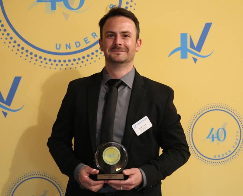 David Loveland poses for a photo with his award during the 40 Under Forty awards banquet on Thursday, March 21, 2024 at Westclox in Peru.