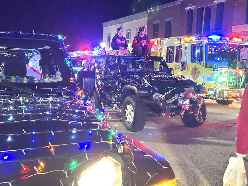 Decorated vehicles and Mt. Morris fire engines and trucks lined up on Wesley Ave. during the lighted parade at Mt. Morris' Christmas in the Village on Saturday, Dec. 7, 2024.