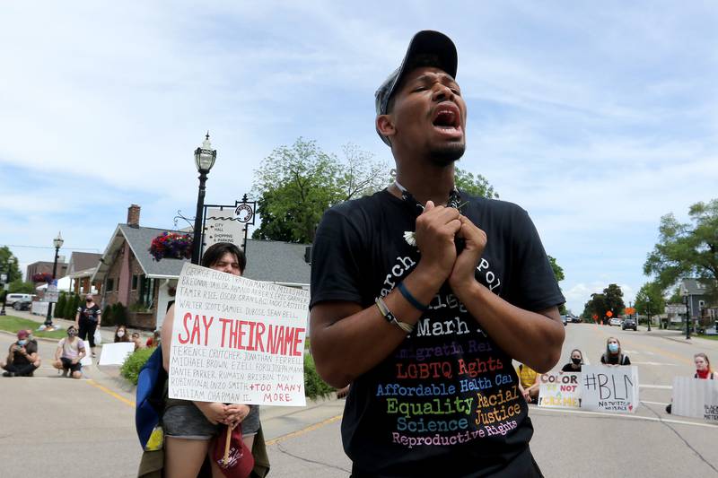 DC Smith of Crystal Lake, 18, reads off the names of African Americans who have died due to police brutality as fellow protest organizer Jesse Scherb, left, holds a sign with their names during a Black Lives Matter protest on Friday, June 5, 2020 in downtown Crystal Lake. More than a hundred peaceful protesters stood and chanted with signs for two hours at the 5-way stop intersection of Walkup Ave, Crystal Lake Ave, and Grant St. Every 20 minutes, the group moved into the crosswalks to block traffic for 7 minutes to raise awareness for the social injustices faced by African American people across the country. Protesters marched peacefully but vocally down Grant St and East Woodstock St to Depot Park to listen to speakers share their experiences and offer ideas to help society battle racism.