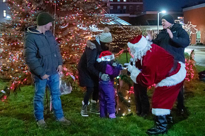 Santa helps Jesstina Johnson push the button to light the KSB tree as her parents Gayana and Ryan Johnson, sister Akara Johnson and the CEO of KSB Dave Schreiner cheer her on during the Dixon Christmas Walk on Friday, December 1st.