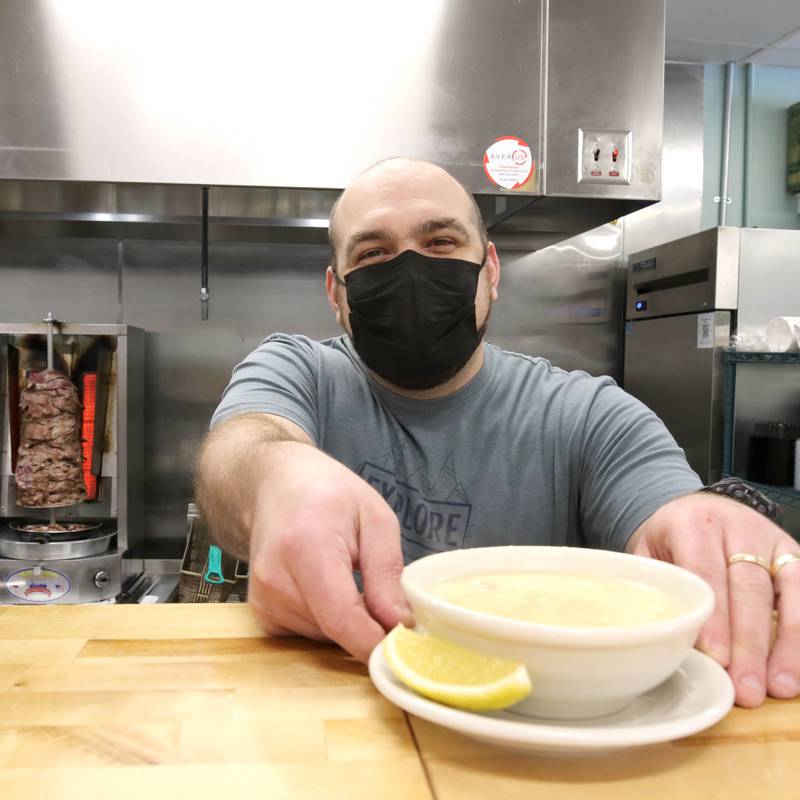 Makie Maratos, co-owner of The Village restaurant, serves a bowl of avgolemono, a Greek chicken and rice soup with a chicken lemon broth thickened with egg, Wednesday, Jan. 19, 2022, at the eatery located at 418 W. State St. in Sycamore. The Village is one of the restaurants that will be participating in Sycamore's Eat Week Jan. 24 through Jan. 31, 2022.