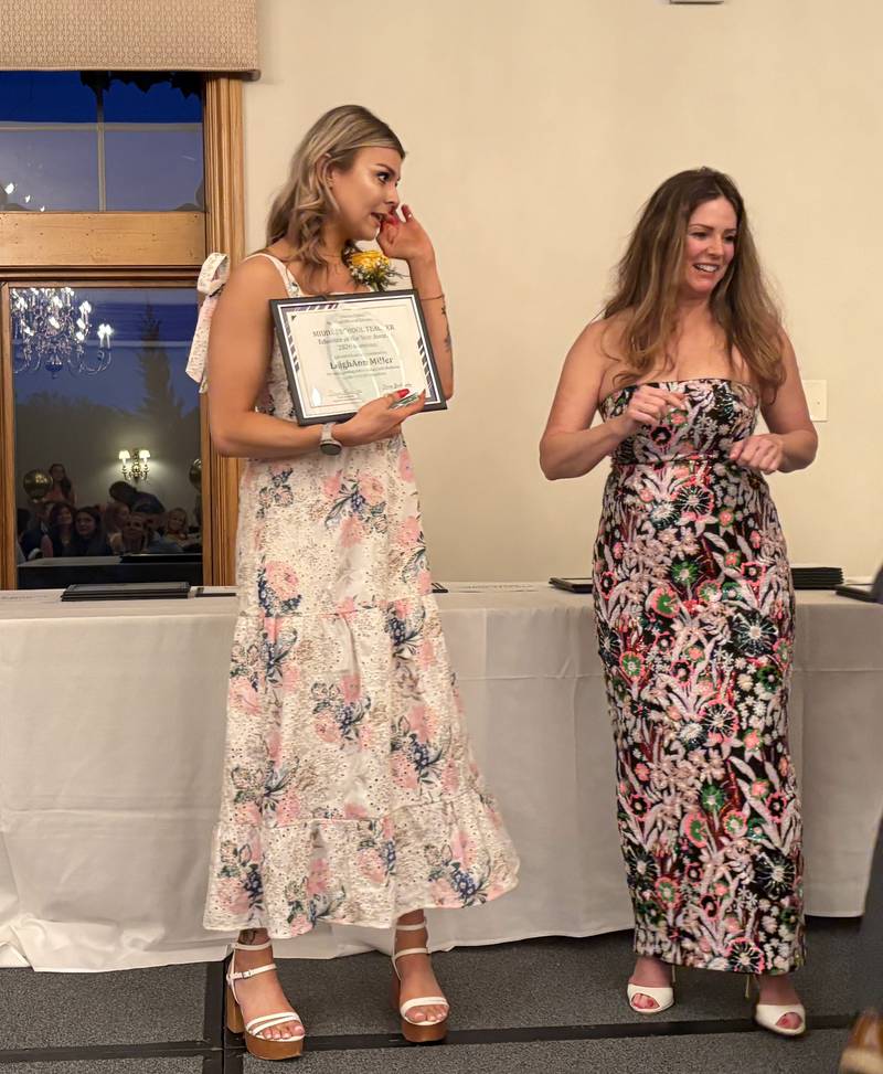 Middle School Teacher award winner LeighAnn Miller, left, gets a gift at the McHenry County Educator of the Year ceremony in Lake in the Hills, Saturday, May 9, 2026.