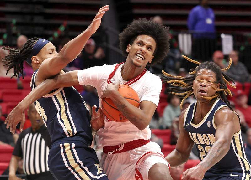 Northern Illinois' Philmon Gebrewhit goes between two Akron defenders defends during their game Tuesday, Jan. 2, 2024, in the Convocation Center at NIU in DeKalb.