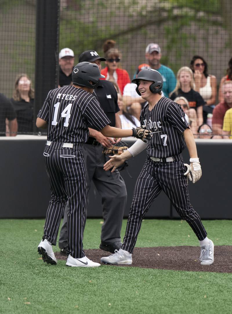 Prairie Ridge's Ryan Myers greets Gabriel Winkelman after he scores a run during their game against McHenry on Friday, May 16, 2025 at McHenry High School. Ryan Rayburn for Shaw Local