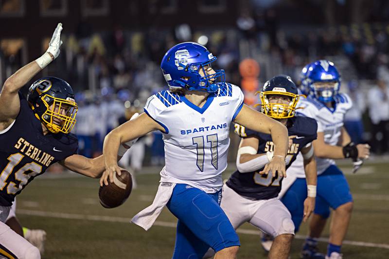 St. Francis’s Alessio Milivojevic scrambles away from Sterling’s Mason Emin Saturday, Nov. 4, 2023 in a class 5A playoff game in Sterling.