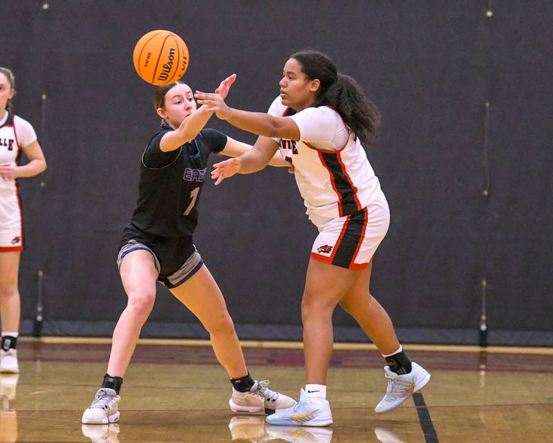 Oswego East's Aubrey Lamberti (1) defends Yorkville's Claire Donelson (33) as she passes the ball during the game on Thursday Dec. 18, 2025, held at Yorkville High School.