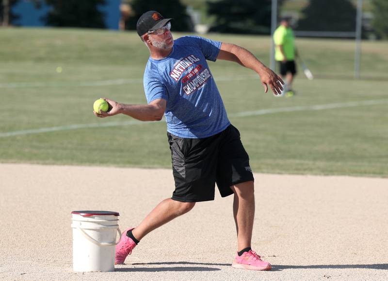 Chris Dierschow, Kishwaukee Valley Storm 17u head coach, demonstrates how to pivot and throw to second base from shortstop Wednesday, June 26, 2024, during 17u practice at the Sycamore Community Sports Complex. The team is preparing for this weekend’s Storm Dayz softball tournament at the complex which draws dozens of teams from throughout the area.
