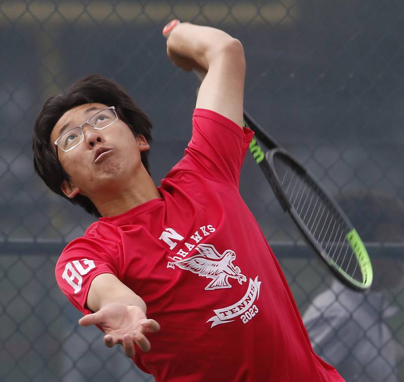 Naperville Central’s Jeremy Zhao serves the ball during an IHSA 2A boys doubles tennis match Thursday, May 25, 2023, at Buffalo Grove High School.
