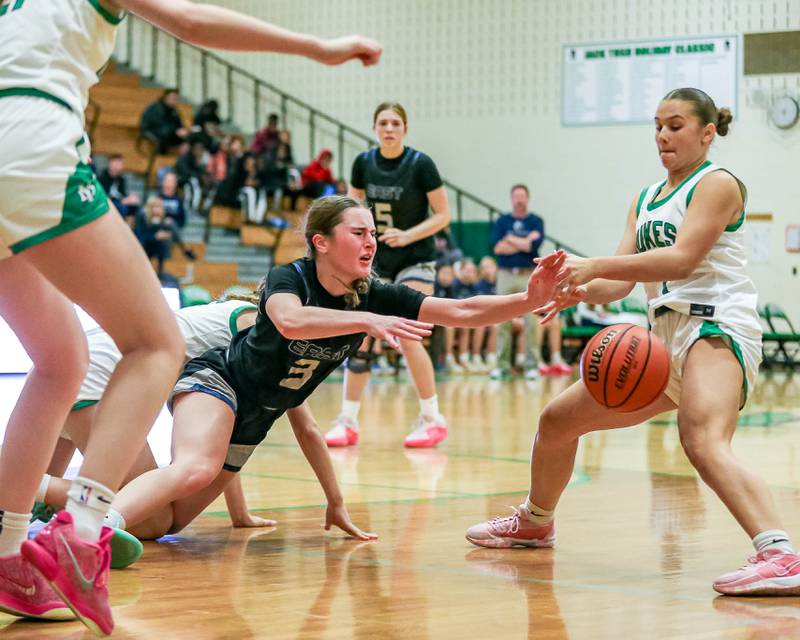 Oswego East's Maggie Lewandowski (3) dives for a loose ball in their York Thanksgiving Tournament game between Oswego East at York on Monday, Nov 18, 2024  in Elmurst.