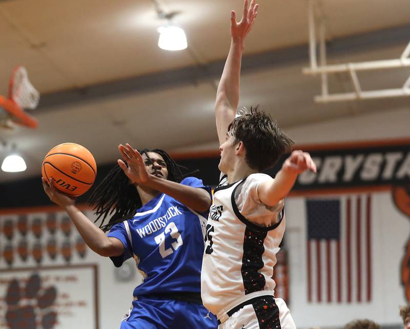 Woodstock's Marc Thomas tries to shoot the ball as she is defended by Crystal Lake Central's Aidan Watson during a nonconference boys basketball game on Monday Jan. 5,  2026, at Crystal Lake Central School.