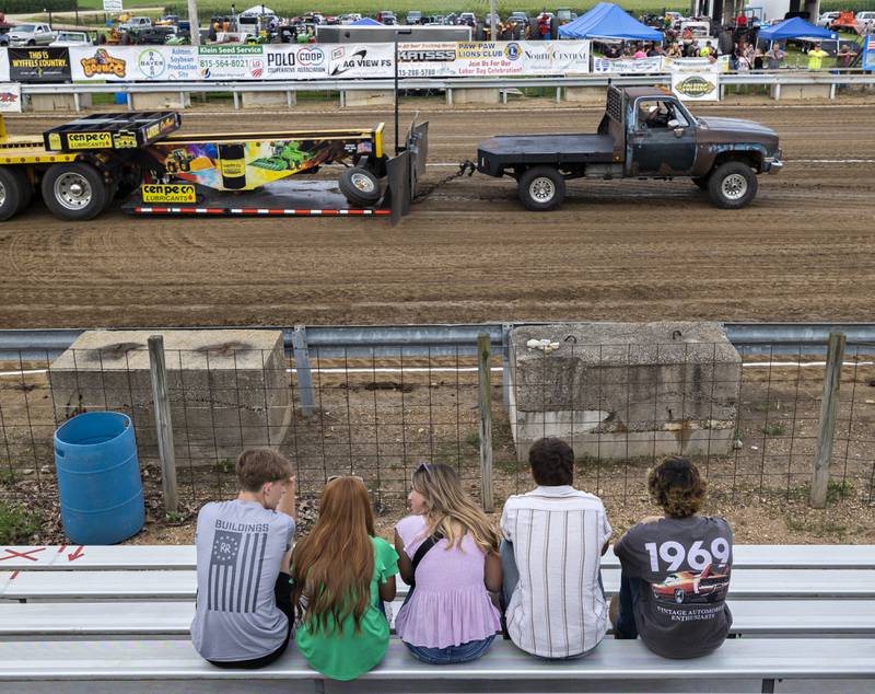 Friends watch as a driver chugs his truck down the track Thursday, July 24, 2025, at the Lee County Fair.