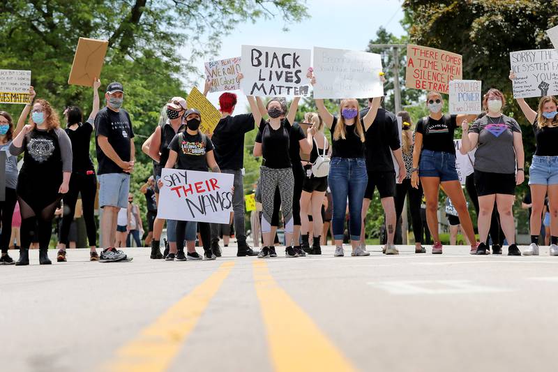 Cars are blocked by protesters in the crosswalk during a Black Lives Matter protest on Friday, June 5, 2020 in downtown Crystal Lake. More than a hundred peaceful protesters stood and chanted with signs for two hours at the 5-way stop intersection of Walkup Ave, Crystal Lake Ave, and Grant St. Every 20 minutes, the group moved into the crosswalks to block traffic for 7 minutes to raise awareness for the social injustices faced by African American people across the country. Protesters marched peacefully but vocally down Grant St and East Woodstock St to Depot Park to listen to speakers share their experiences and offer ideas to help society battle racism.