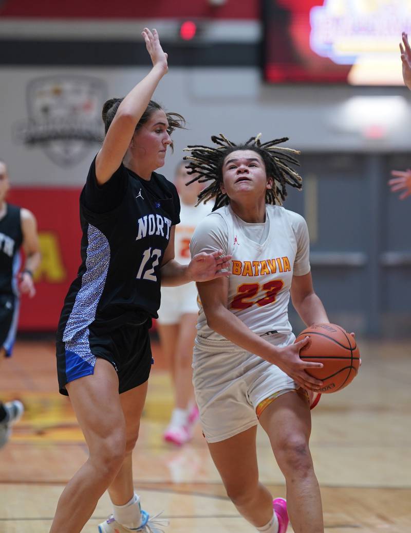 Batavia’s Addie Prewitt (23) drives to the hoop against St. Charles North's Riley Barber (12) during a basketball game at Batavia High School on Tuesday, Dec 5, 2023.