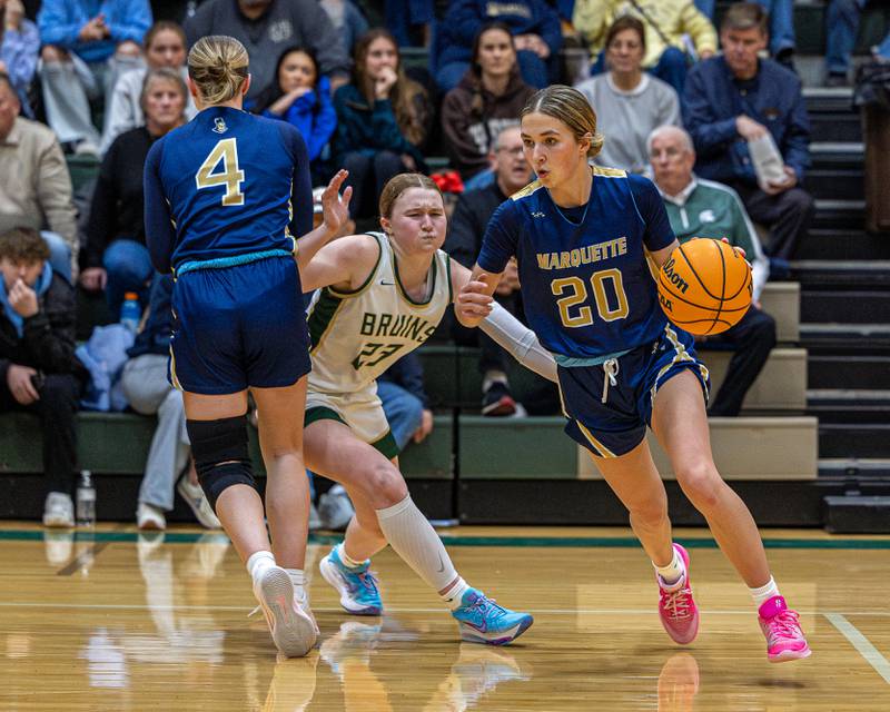 Kaitlyn Davis (20) of Marquette dribbles ball off screen from teammate Hunter Hopkins (4) as Lili McClain (23) of St. Bede is caught up in screen on Friday, January 16, 2026 at St. Bede Academy in Peru.