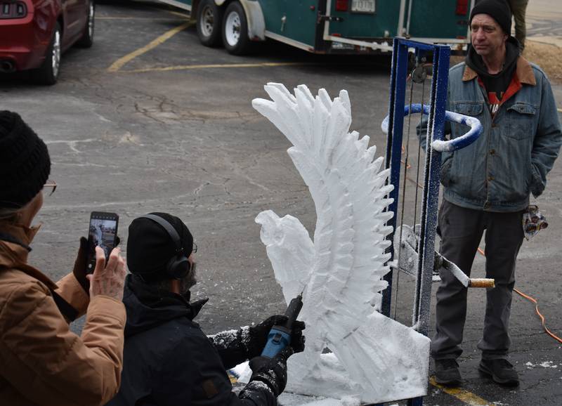Robert Storm of Moline carves an eagle out of ice Saturday, Feb. 8, 2025, at Flock to the Rock in Rock Falls.