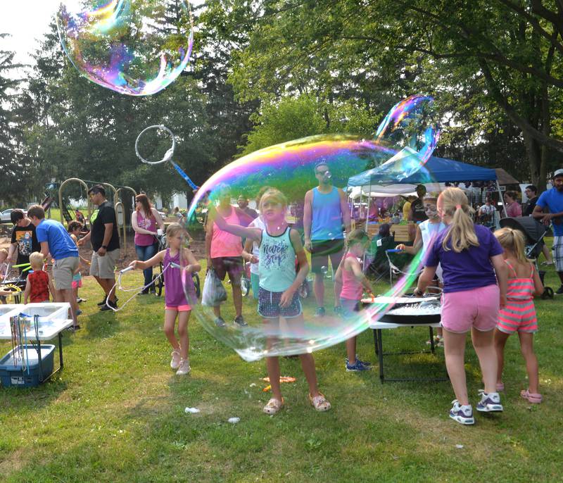 Jaedah Quenzer, 8, of German Valley, watches as the big bubbles she made travel across Ben Miller Park at Jason Kollum's "Big Bubble Time' bubble event during German Valley Days on Saturday, July 15, 2023.