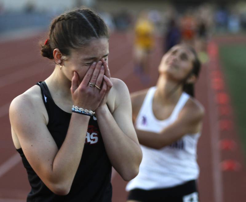 Huntley’s Morgan Sauber and Hononegah’s Kylie Simpson react to finish third and fourth in the 800 meter run during the Huntley IHSA Class 3A Girls Sectional Track and Field Meet on Wednesday, May 8, 2024, at Huntley High School.