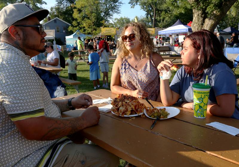 Jesus (from left), Diana and Kamila Gonzalez, all of Aurora, share a giant plate
of nachos at Montgomery Fest on Friday, Aug. 15, 2025.