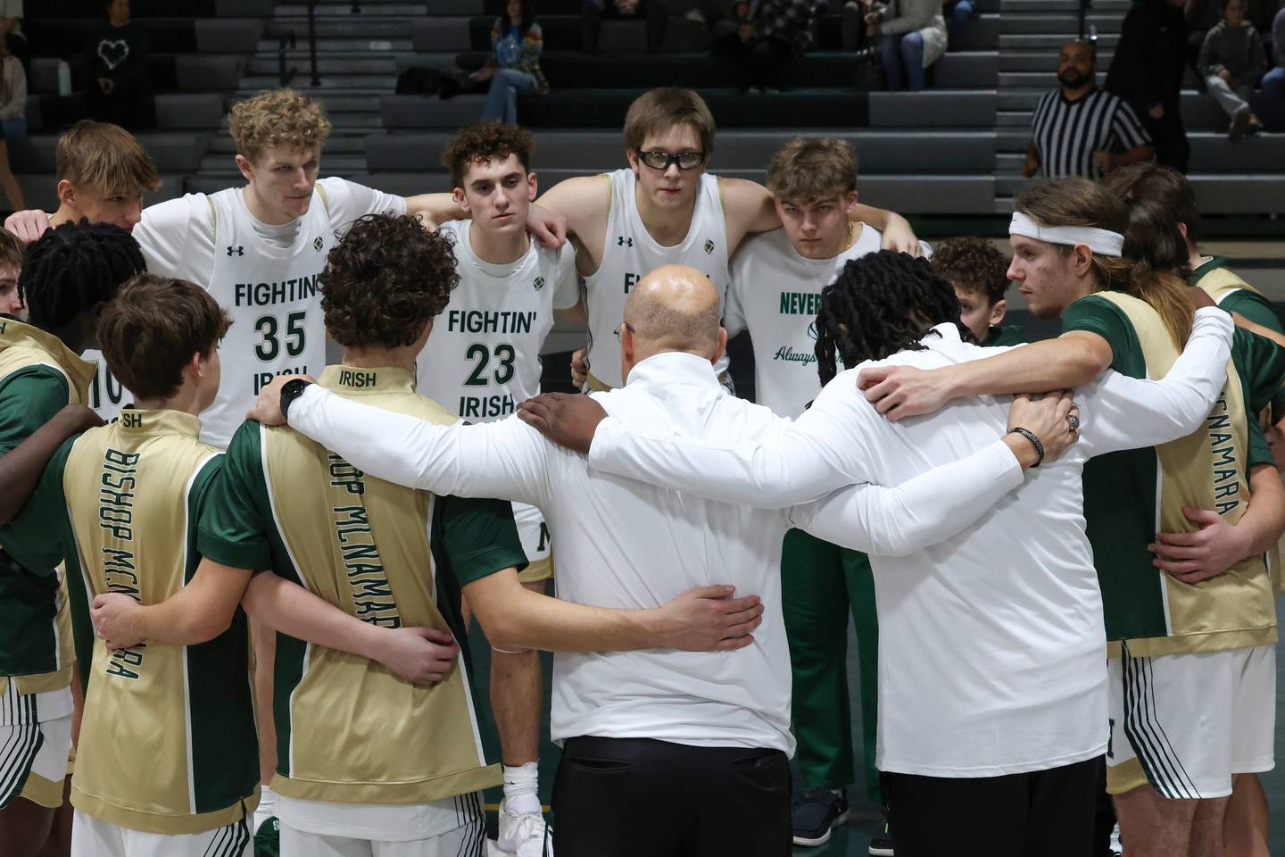 Bishop McNamara head coach Adrian Provost, center, gathers with his team ahead of the Fightin' Irish's home game on Wednesday, Jan. 7, 2026.