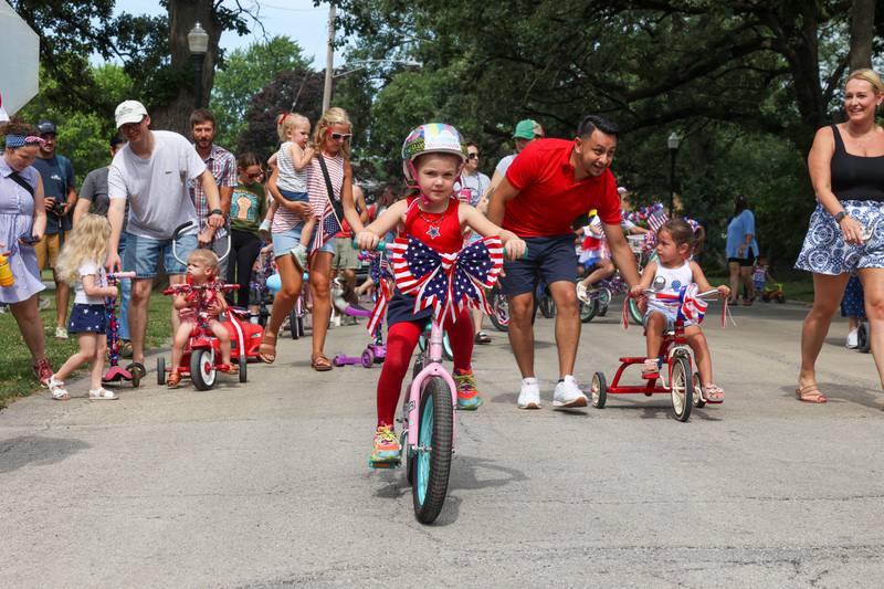 Adelaide Martin, 5, of Kankakee, pedals her decorated bike in the Kids' Bike Ride during the Riverview Historic District's annual 4th of July Celebration on Friday, July 4, 2025.