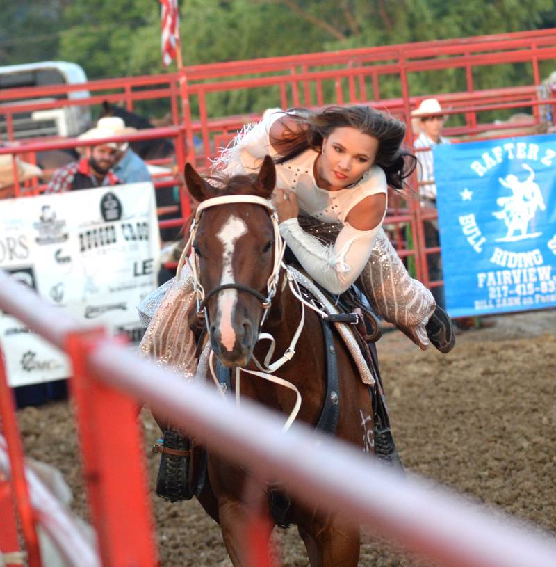 Trick rider Saige McNeill performs in the T & A Bucking Bulls Rodeo at the Ogle County Fair on Friday, Aug. 1, 2025 in Oregon.