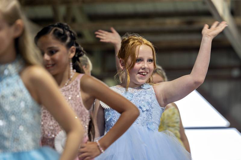 Raya Windham, 9, waves in the Ogle County Young Miss pageant Thursday, July 30, 2025, at the Ogle County Fairgrounds.