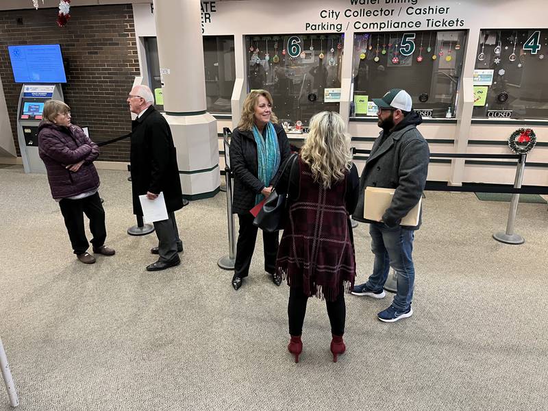Pat Mudron (second from the left), Joliet City Council District 2 candidate, Sherri Reardon, Joliet City Council District 3 candidate, and JR Patton, (first from the right), a designee for Terry D'Arcy, Joliet mayor candidate, wait for the city clerk's office to open at 8 a.m. on Monday, Dec. 12, 2022, to file candidacy petitions. Monday marked the first day for mayoral and council candidates to do so.