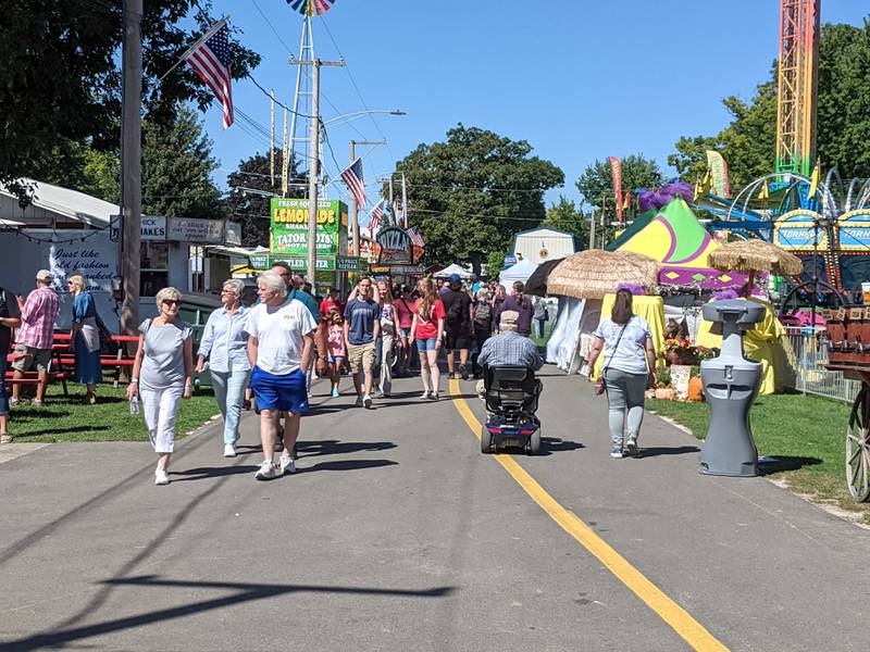 People stroll through the fairgrounds at the Sandwich Fair during the fair's opening day on Sept. 4, 2024.