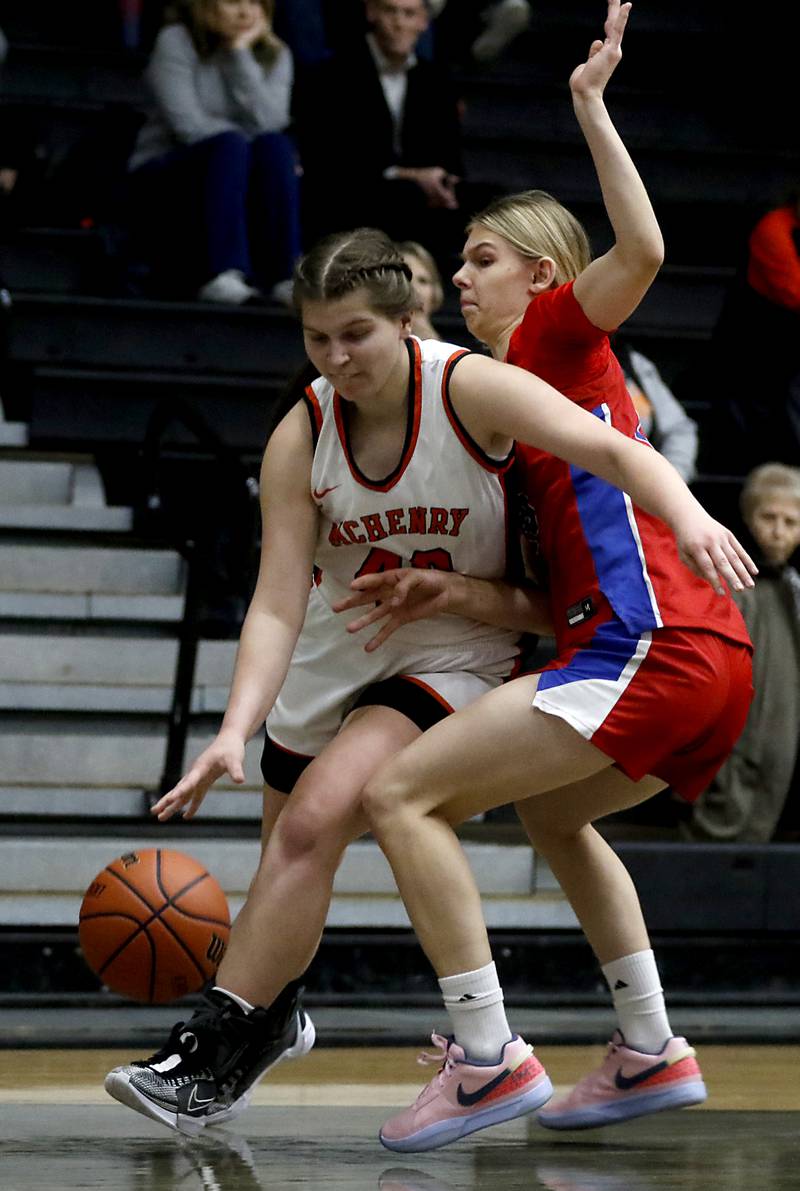 McHenry's Erin Nothdorf drives to the basket against Monica Sierzputowski during a Fox Valley Conference girls basketball game on Tuesday, Dec. 12, 2023, at McHenry High School.