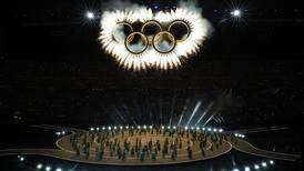 Olympians march in Milan and the mountains at a multi-site opening ceremony for the Winter Games