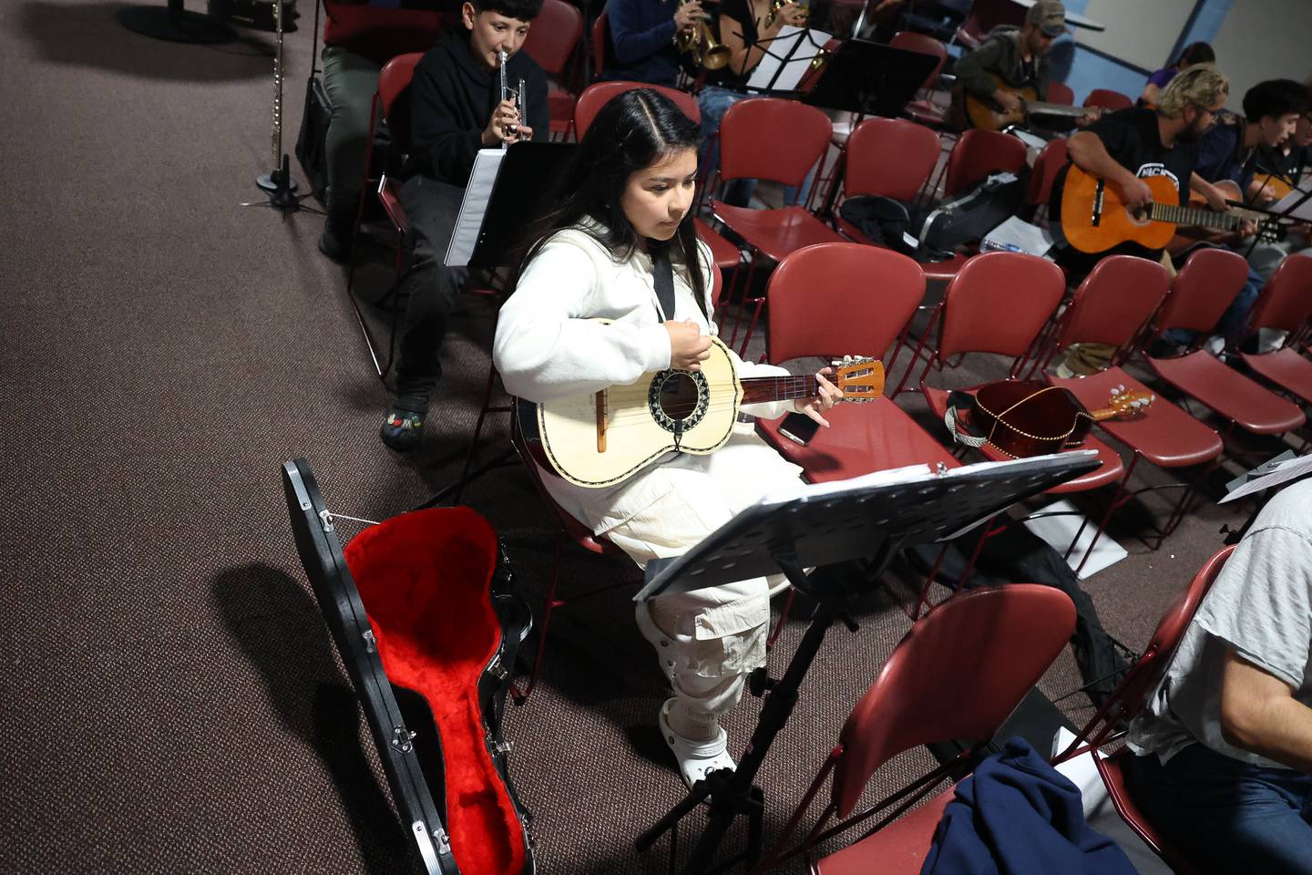 Marely Flores practices with Mariachi de Joliet, a community Mariachi band, for an upcoming fundraiser performance at the Rialto Square Theatre in Joliet.
