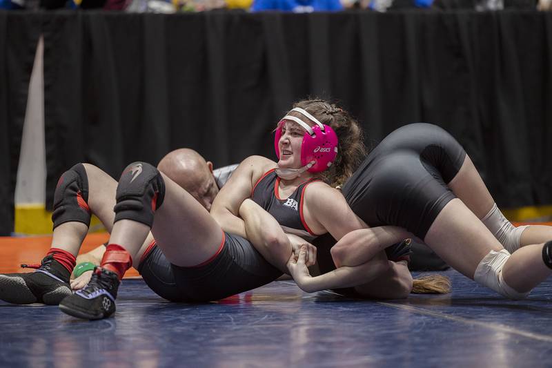 Mt Zion’s Sydney Cannon works on Morris’ Ella McDonnell in the 110 pound third place match at the IHSA girls state wrestling championship Saturday, Feb. 25, 2023.