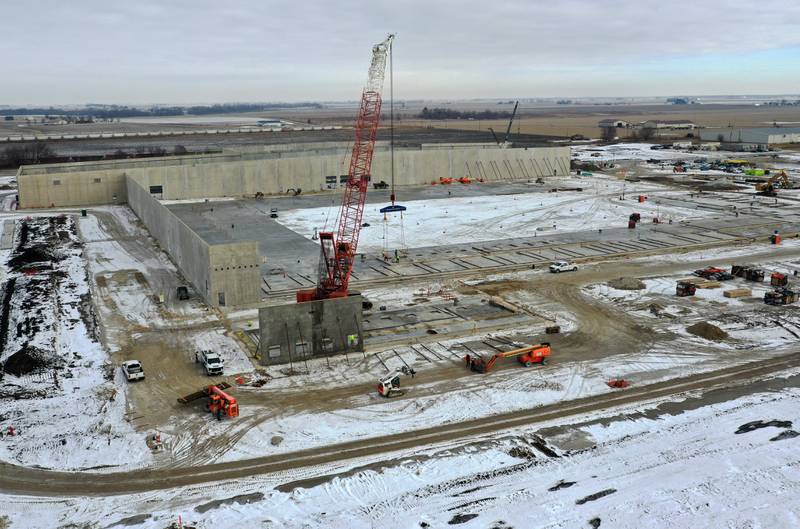 Workers use a large crane to lift a portion of an exterior wall at the new GAF Commercial Roofing manufacture on Tuesday, Jan. 24, 2023 in Peru. Last July, GAF and the City of Peru announced $80 million, 450,000 square foot manufacturing facility that broke ground in late 2022. The plant will employ more than 70 workers and will be located north of Interstate 80 and west of Plank Road on the OmniTRAX rail line.