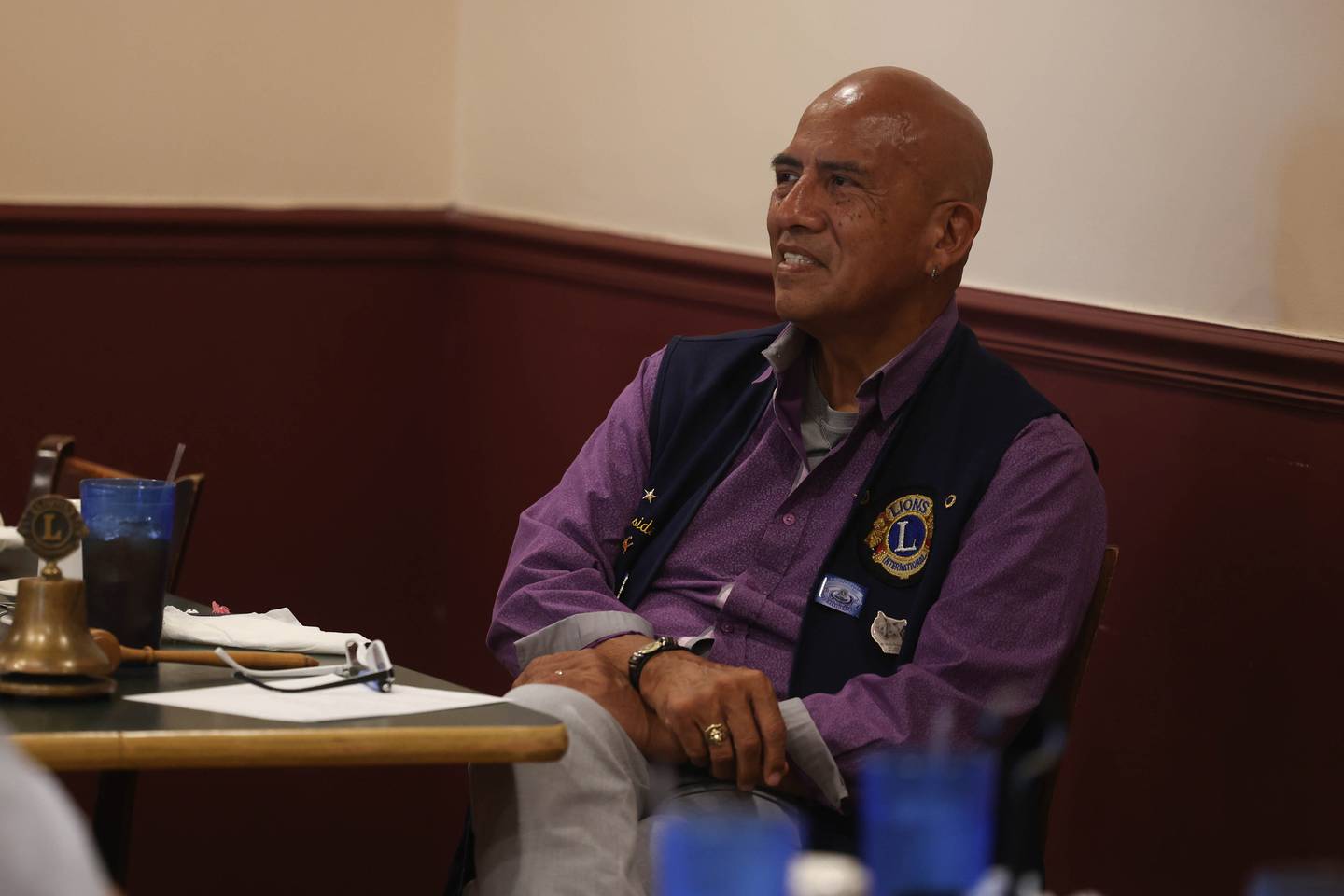 Joliet Noon Lions Club President Philip Martinez listens to updates on a community project during the chapter’s afternoon meeting at the Silver Spoon restaurant on Thursday, Sept. 22, 2022, in Joliet. The Joliet Noon Lions Club, a community outreach organization, celebrated its 101st anniversary this year.