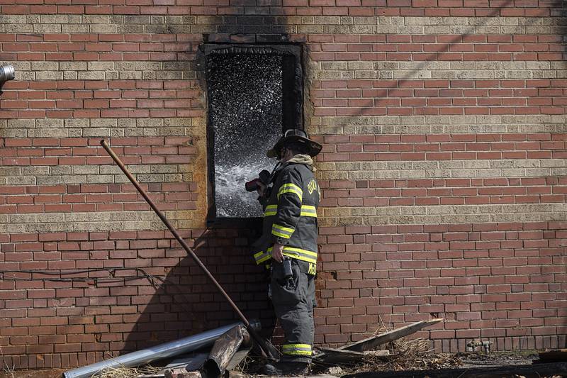 Dixon City firefighters work to extinguish hot spots in the afternoon on Monday, March 2, 2026, after previously fighting a fire in the 1100 block of West First Street. Dixon City responded to the fire at 2:21 a.m. and cleared the scene at 6:19 a.m.