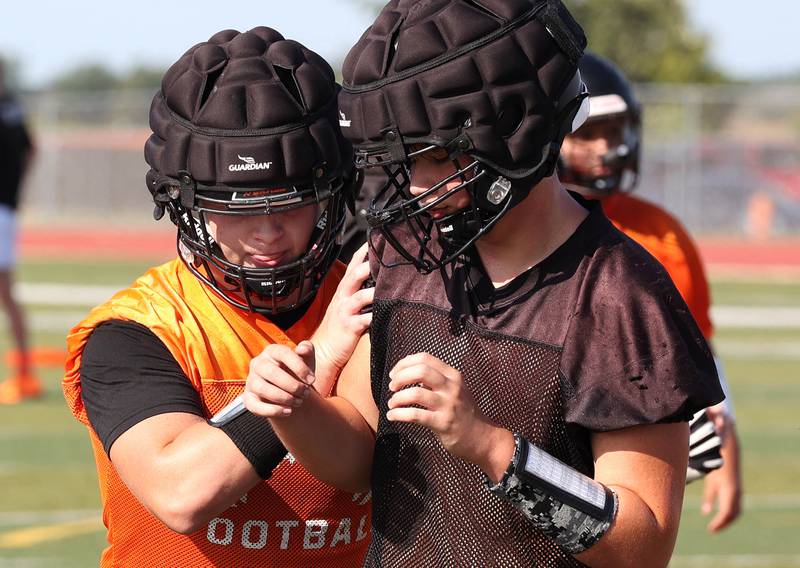 Dekalb’s Owen Sisson (left) goes through a drill in August 2024 at the school during the first practice of the regular season.
