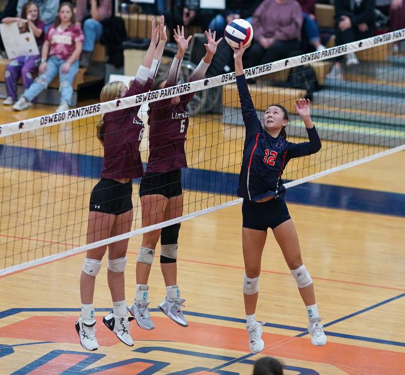 Lockport's Kylee Schurig (6) and Kyla Mitchell (8) defend the net against Oswego’s Ava Flanigan (12) during a class 4A Oswego Sectional semifinal match at Oswego High School on Monday, Oct. 30, 2023.