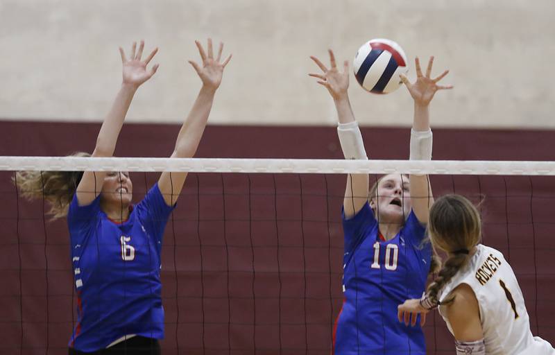 Lakes’ Elizabeth Hemmer (left) and Isabel Stauber (center) tries to block the hit of Richmond-Burton's Sophia Komar during a nonconference volleyball match  on Monday, Sept. 29, 2025, at the Richmond-Burton High School in Richmond.