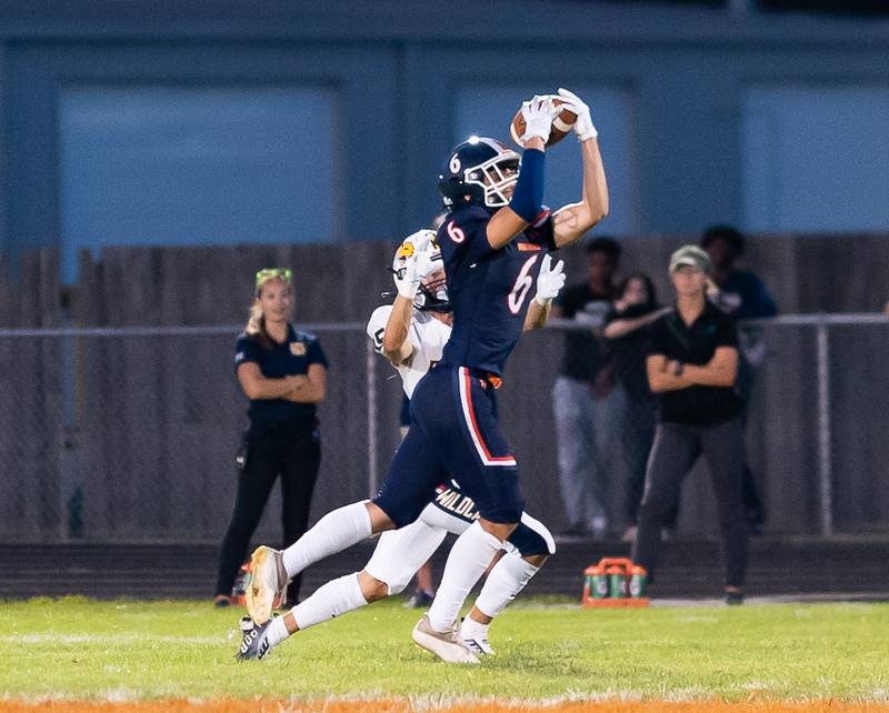 Oswego’s Brady Hayslett (6) intercepts a pass intended for Neuqua Valley's Carter Stare (15) during a football game at Oswego High School on Friday, Aug 26, 2022.