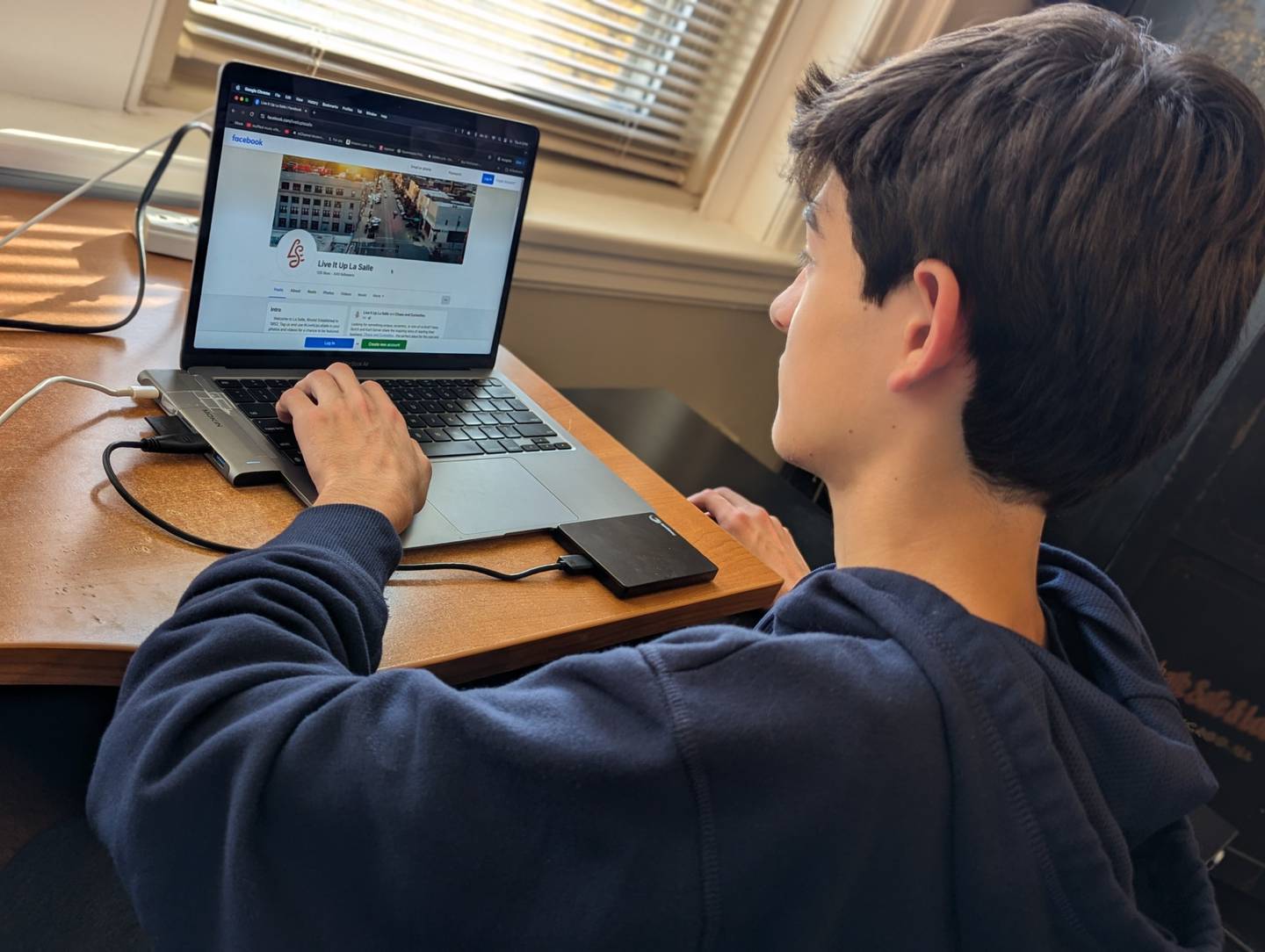 Daniel Duncan reviewing the Live it Up La Salle Facebook page.