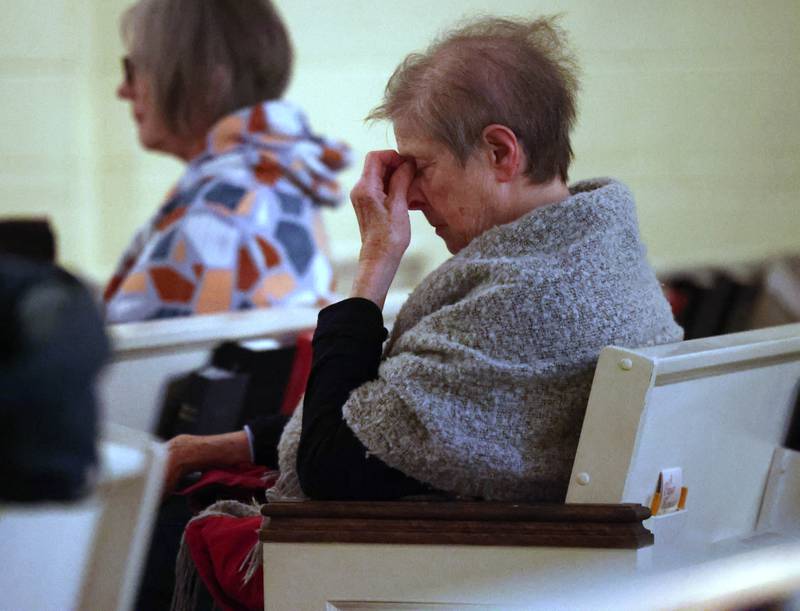 An attendee sits in quiet reflection Monday, Feb. 2, 2026, during the Vigil for Peace at the First Congregational United Church Of Christ in DeKalb. The vigil is being held in remembrance of those lost in recent ICE related shootings and to show solidarity with the people of Minnesota.