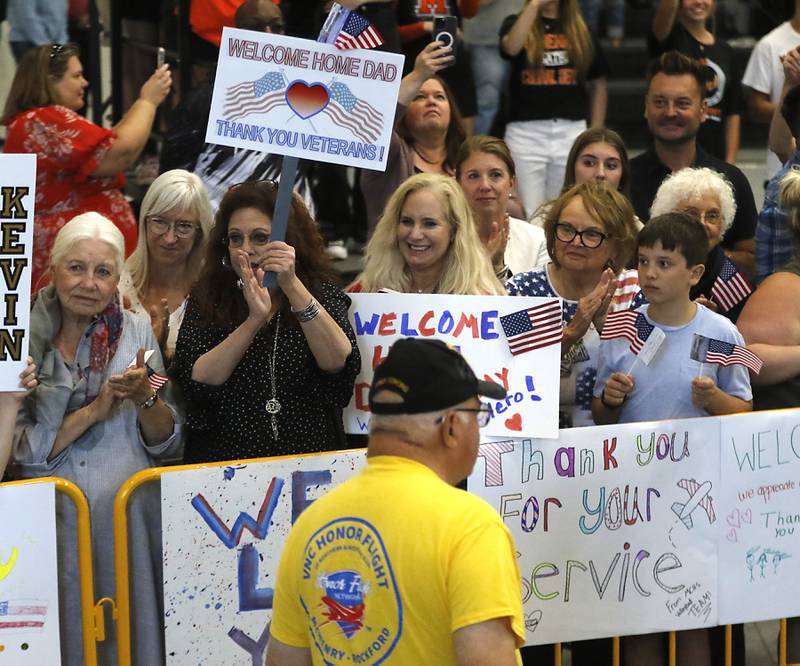 People clap and cheer as veterans returning from an Honor Flight trip to Washington D.C.,  are celebrated on Sunday, Aug. 27, 2023, at McHenry Community High School’s Upper Campus.